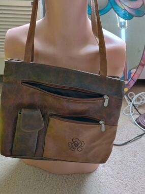 brown leather shoulder tote bag featuring a distressed finish, multiple exterior